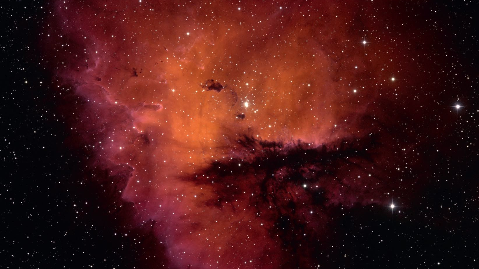 Aussi bien photographiquement que visuellement, la forme de NGC 281 rappelle le personnage Pac-Man. NSF/AURA/WIYN/T. Recteur (University of Alaska)